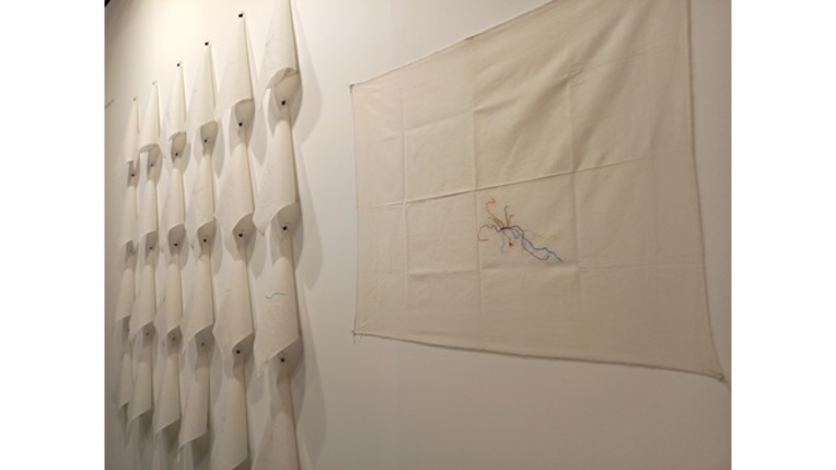 Gina Arizpe. "Migratory Traces", 2014-2019. 
Installation. 25 pieces of hand-embroidered fabric. 24 correspond to the journeys of women street vendors from their home village to Mexico City, and one is the sum of all the journeys.