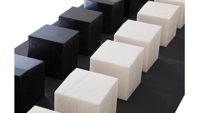 Elena Asins, "Albiku trikuharri". 2000. 8 pieces of alabaster and 8 pieces of black stone from Zimbabwe. 12 x 12 x 12 cm each.